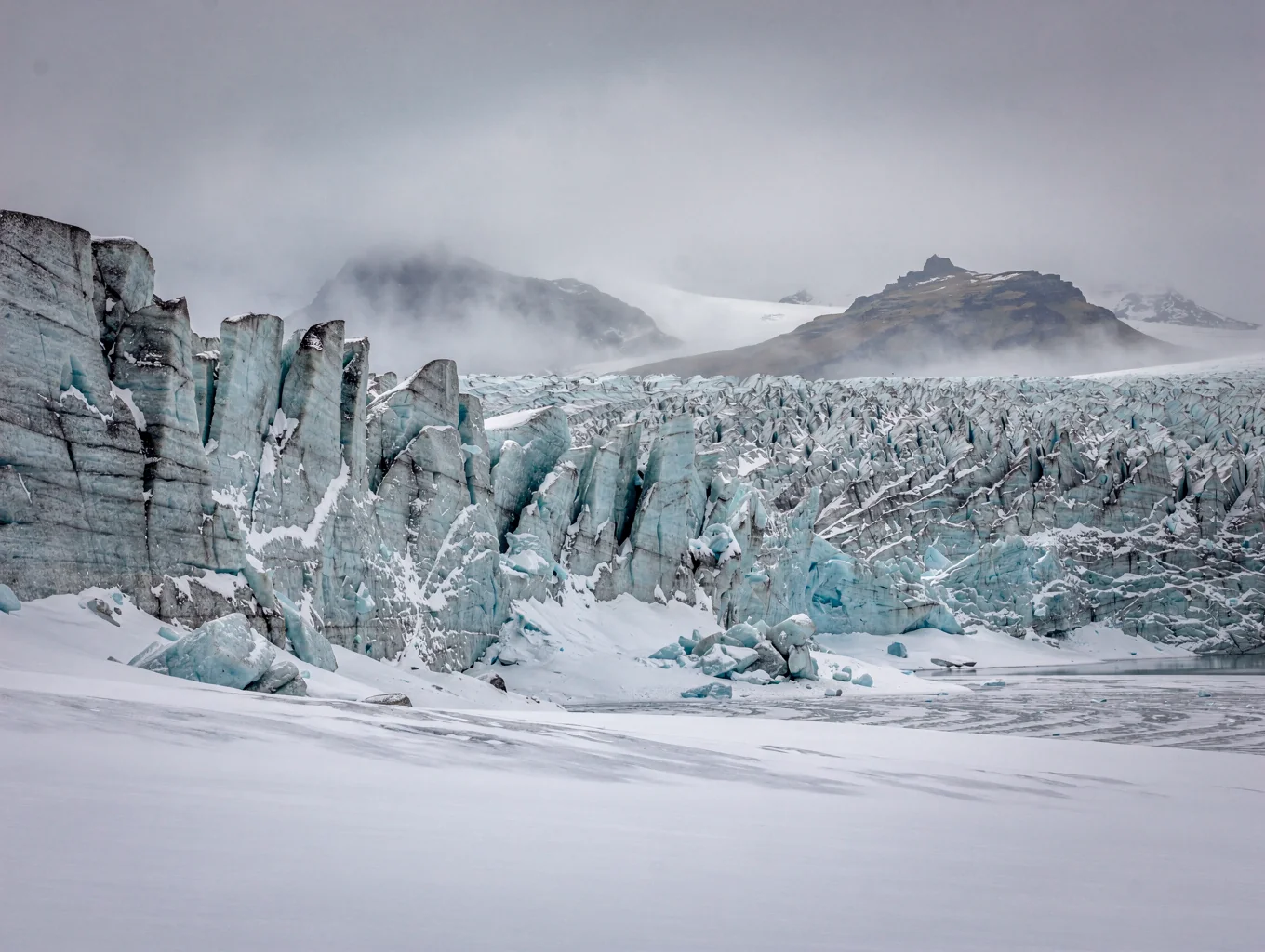 Glacial ice formations in Iceland with deep blue tones