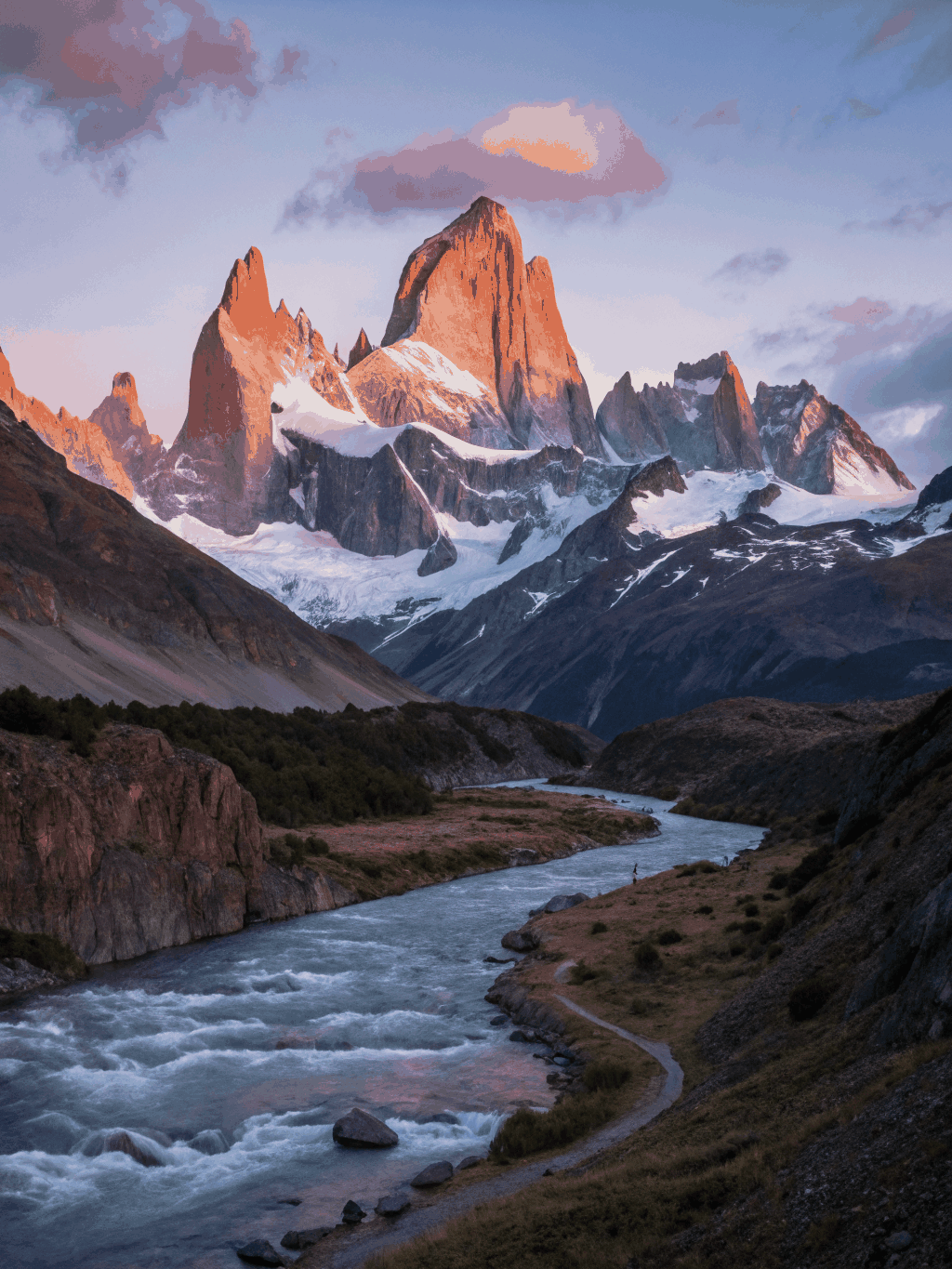 Mount Fitz Roy towering peak bathed in early golden sunrise light